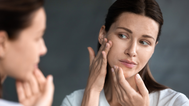 woman looking at face