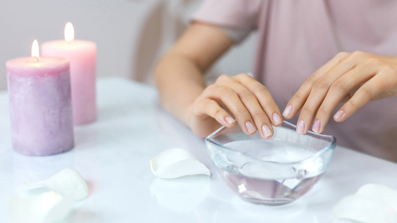 Person getting manicure with clear polish