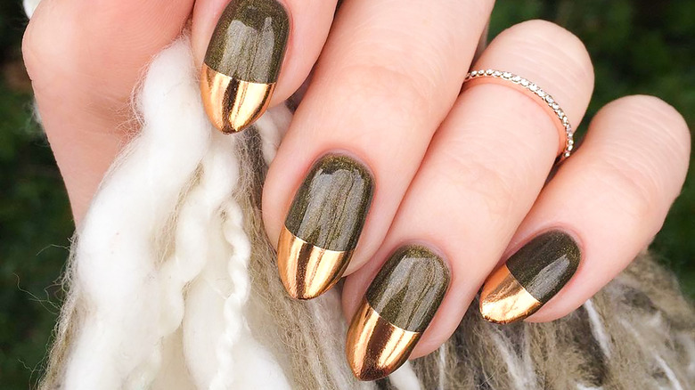 Woman with gold metallic nail polish