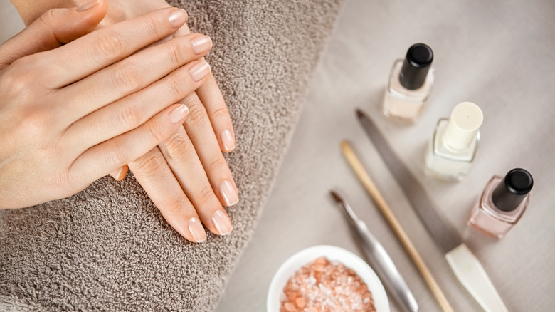 hands with manicure products