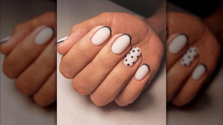 a person's hand with rounded manicured nails