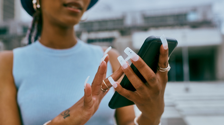 Woman with white acrylic nails