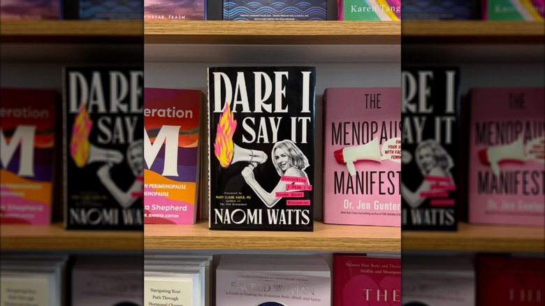 Photo of a bookshelf featuring Naomi Watts' book "Dare I Say It: Everything I Wish I'd Known About Menopause"