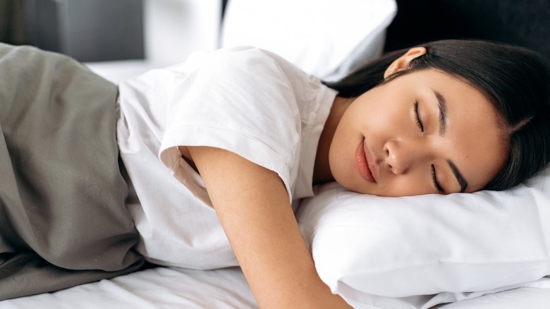 Young woman sleeping in bed