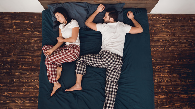 couple lying on navy bed