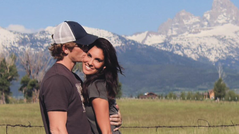 Daniela Ruah and husband David Olsen pose for a photo together in a field