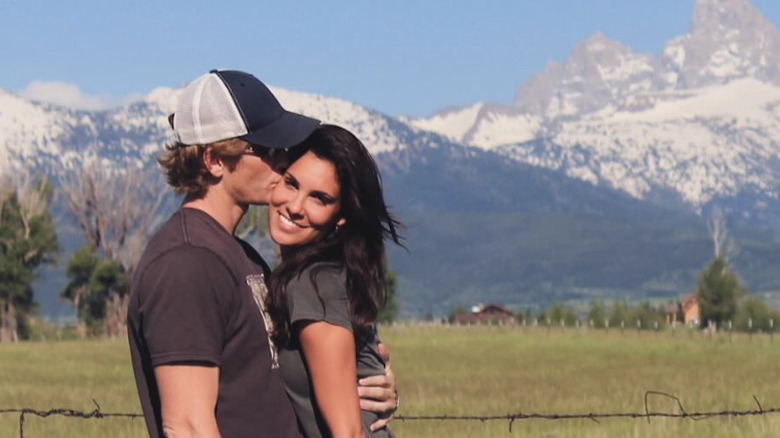 Daniela Ruah and husband David Olsen pose for a photo together in a field