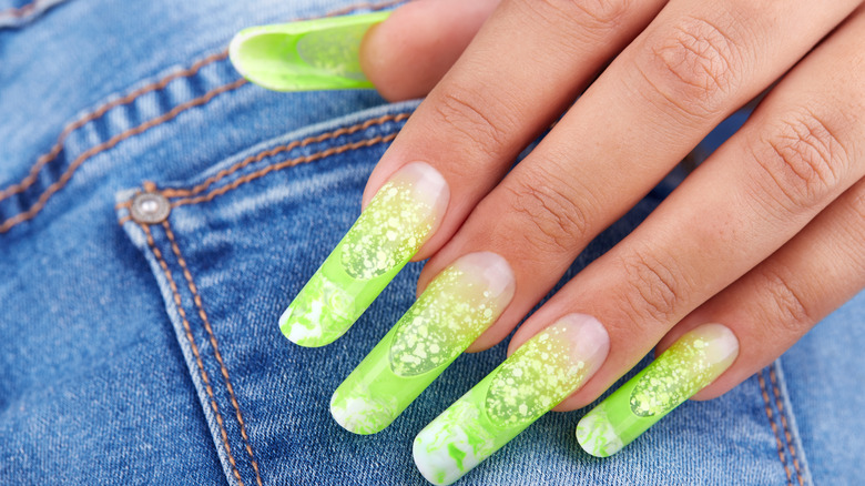 woman with neon green nails