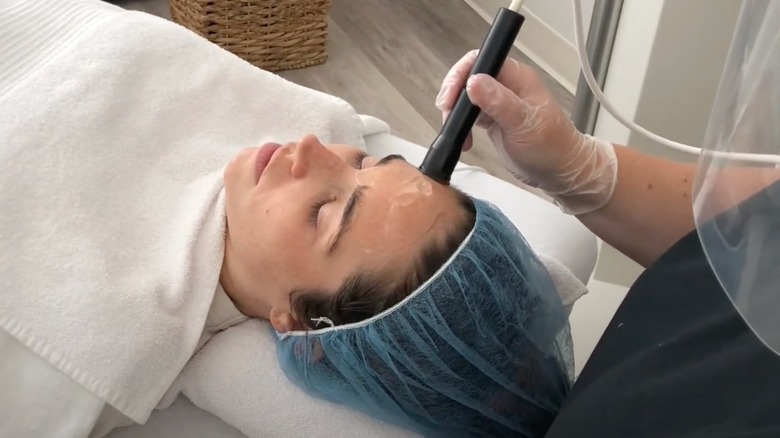 Woman receives cold laser facial