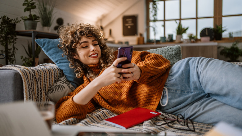 woman on sofa with phone