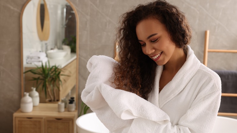 Woman drying hair with towel