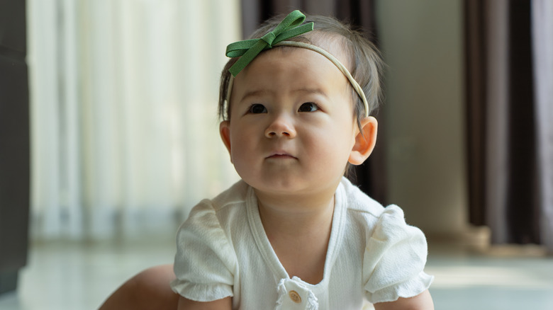 Baby with a green headband