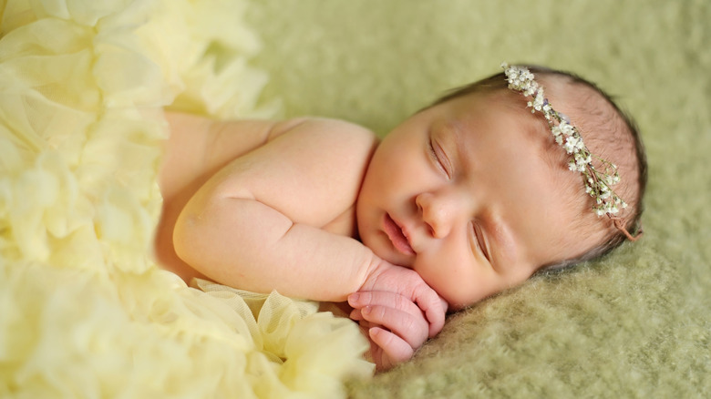 Baby sleeps wearing a yellow tutu