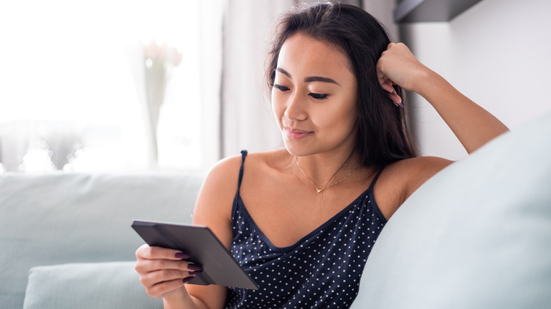 woman reading e-book on e-reader