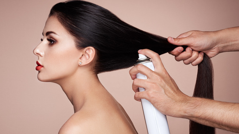 Woman using dry shampoo