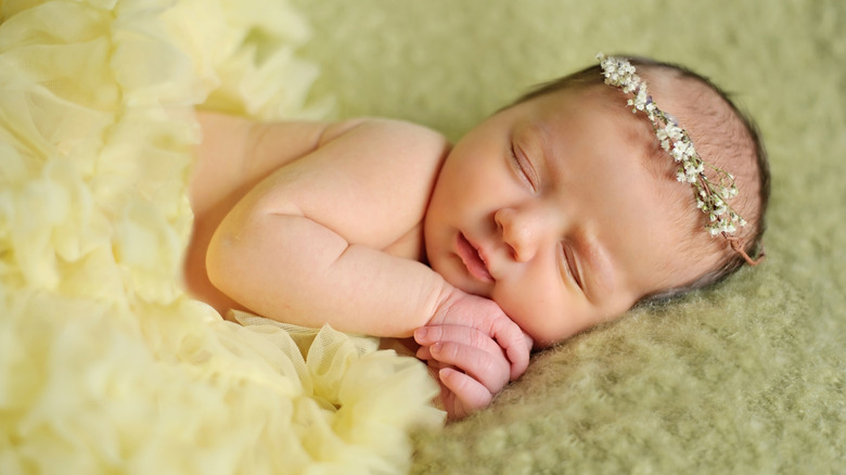 A newborn baby wearing a dainty crown