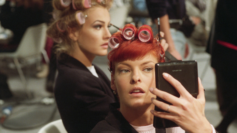 Linda Evangelista with her hair in rollers