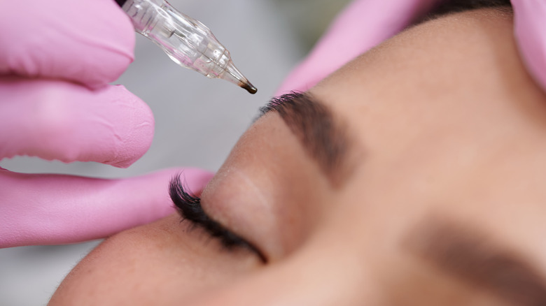 woman getting her eyebrows done