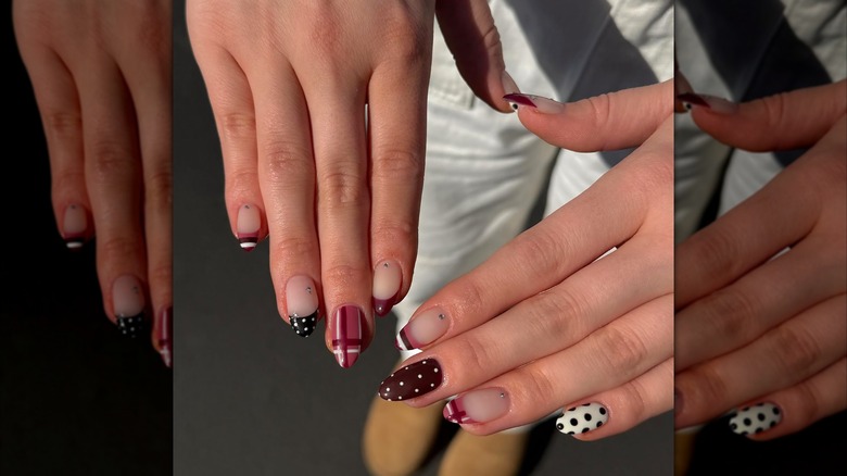 Nails with nail art and rhinestones.