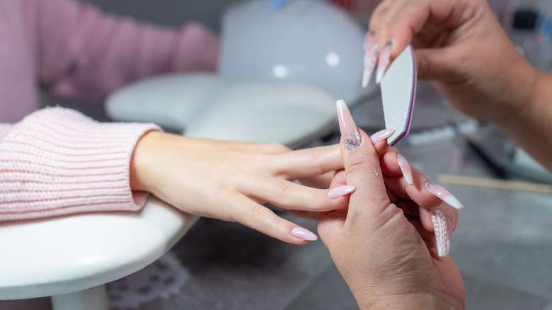 A woman getting her nails done.