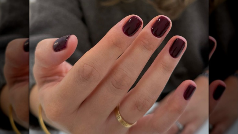 Woman with burgundy nails