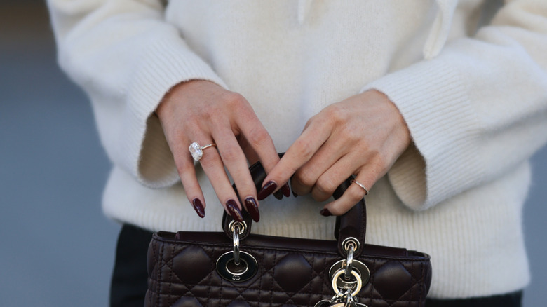 Woman with dark brown manicure