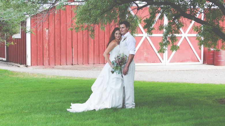 Couple in front of a barn
