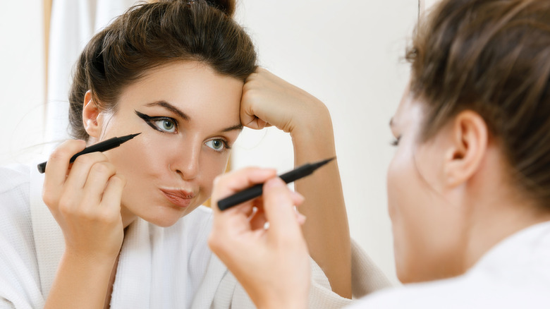 woman making mistake with eyeliner