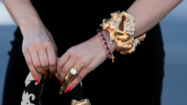 Closeup of a guest's mixed metal jewelry stack at Paris Fashion Week 2026