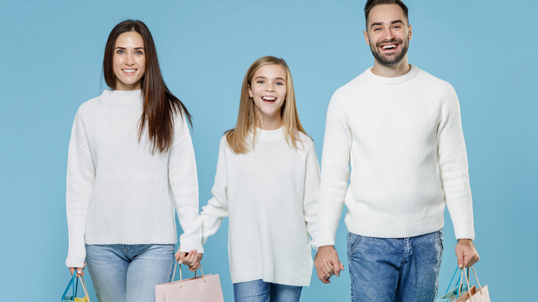 Mother, father, and child with shopping bags