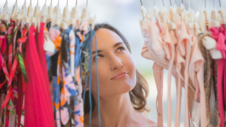 Asian woman looking at swimsuits