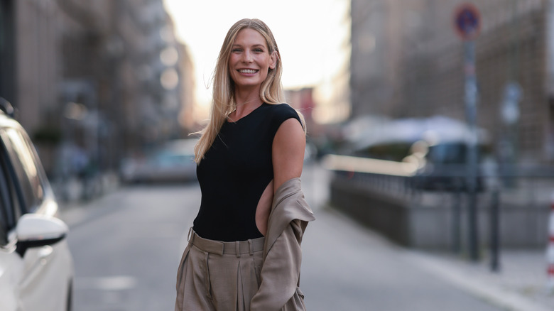 Woman wearing bodysuit under jacket