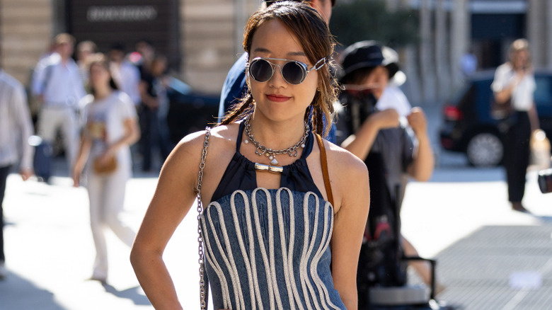 A woman wearing a charm necklace