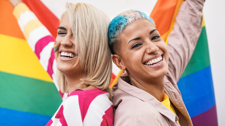 Couple waving rainbow flag