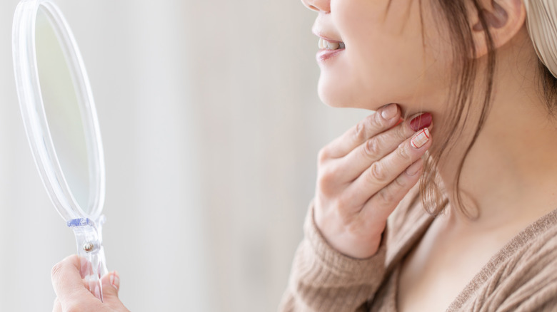 woman pinching her chin