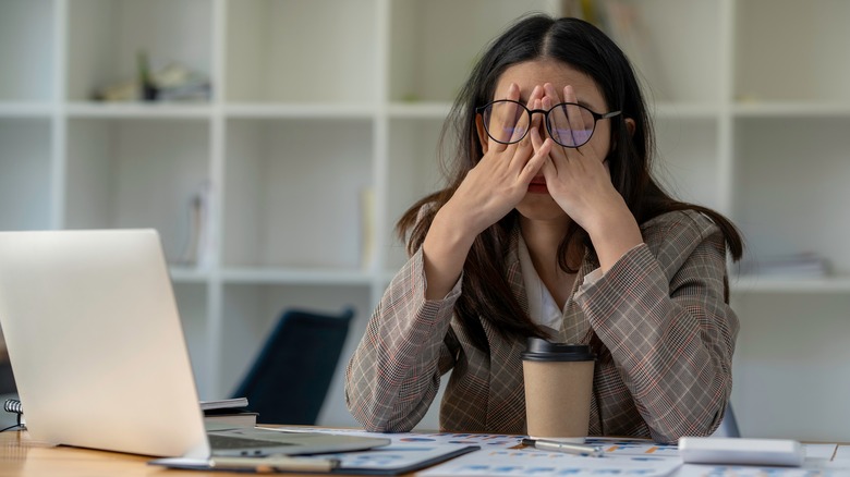 woman hung over at work