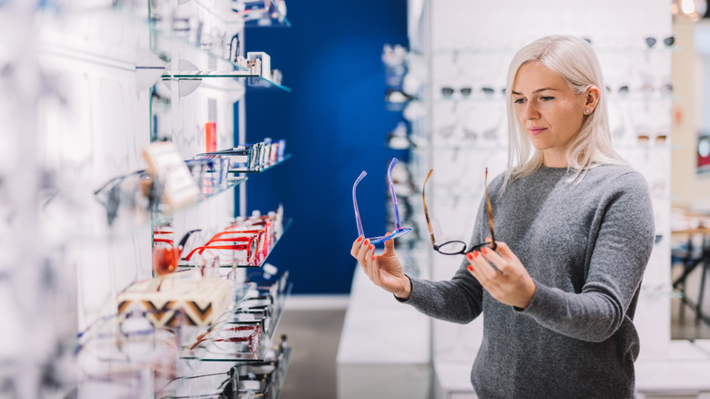 comparing glasses at optics store