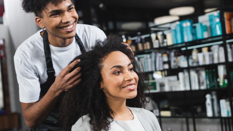 Woman with hairdresser at salon