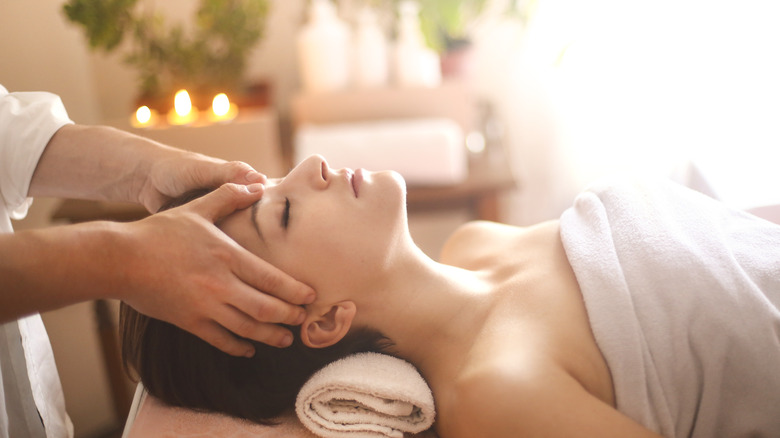 Woman receiving head massage