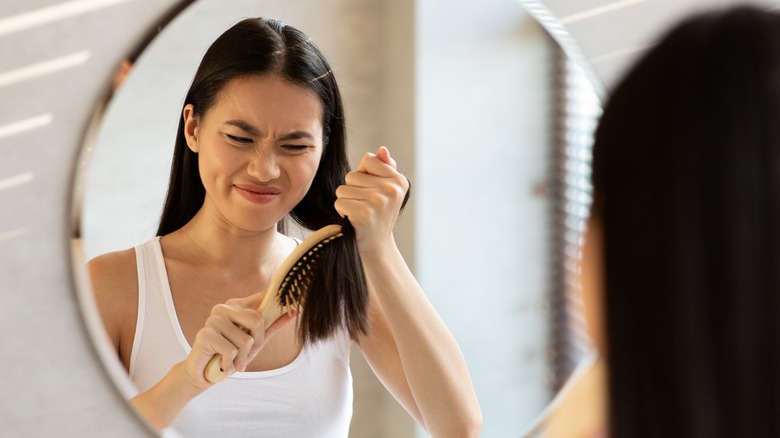 Person combing their thick hair 