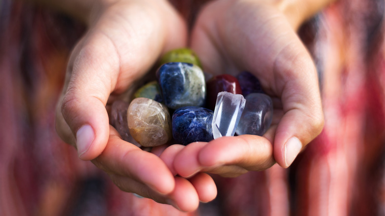 woman's hands holding crystals