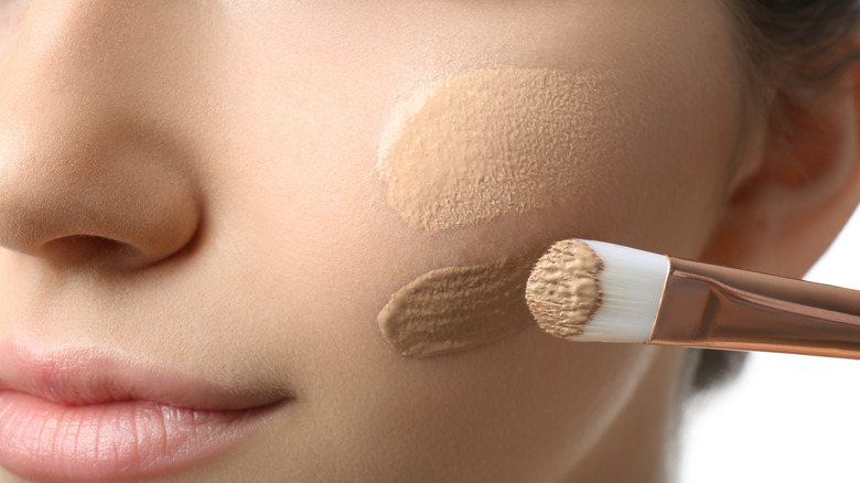 Woman applying makeup