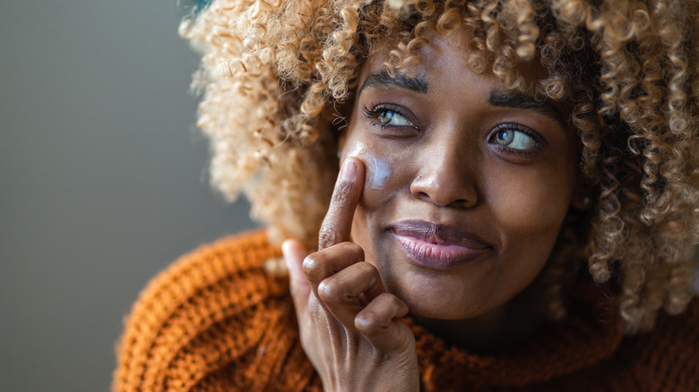 Woman applying face cream