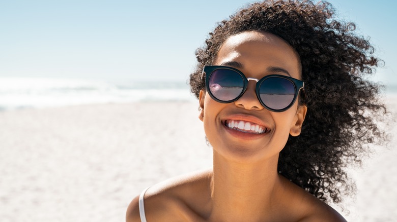 Smiling girl wearing black sunglasses