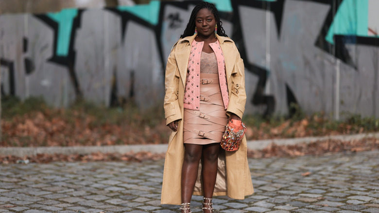 Woman wearing long coat and over the knee skirt