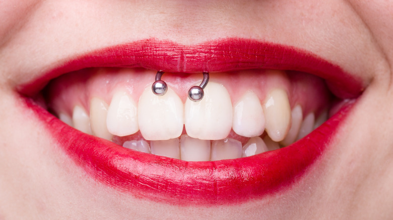 Smiling mouth with smiley piercing