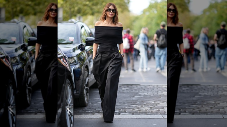 A woman in an all-black slim-fitting outfit
