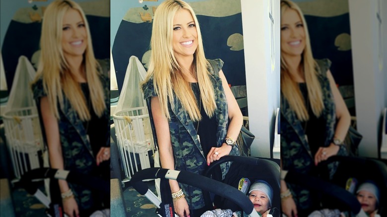 Christina Haack stands beside her baby in a stroller