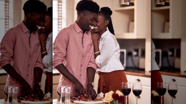 A couple prepares food in the kitchen