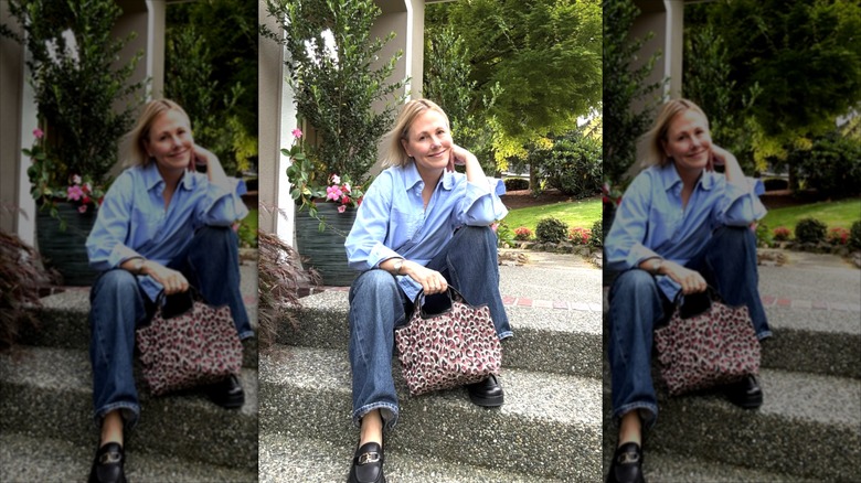 Lynette Marcus wearing a shirt and jeans, and holding a bold leopard-print handbag